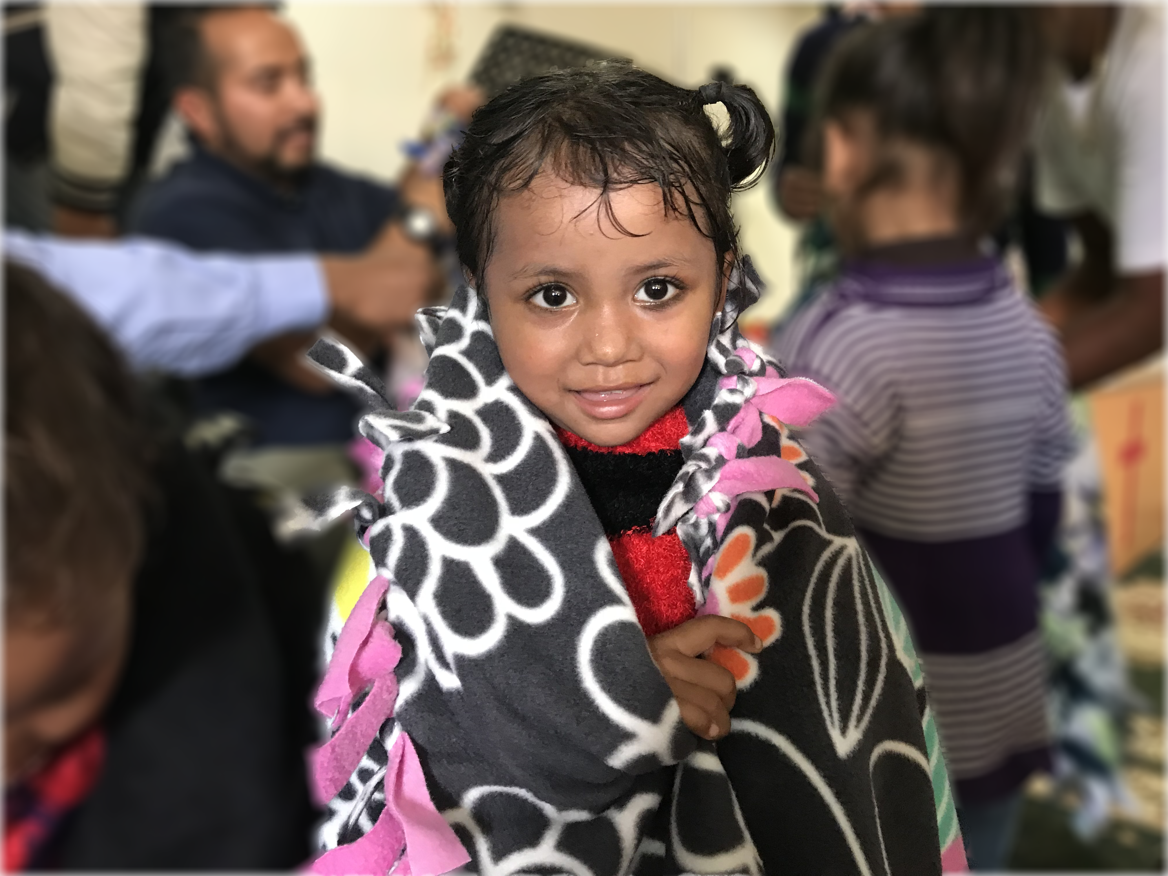 Girl wrapped in cozy knit blanket